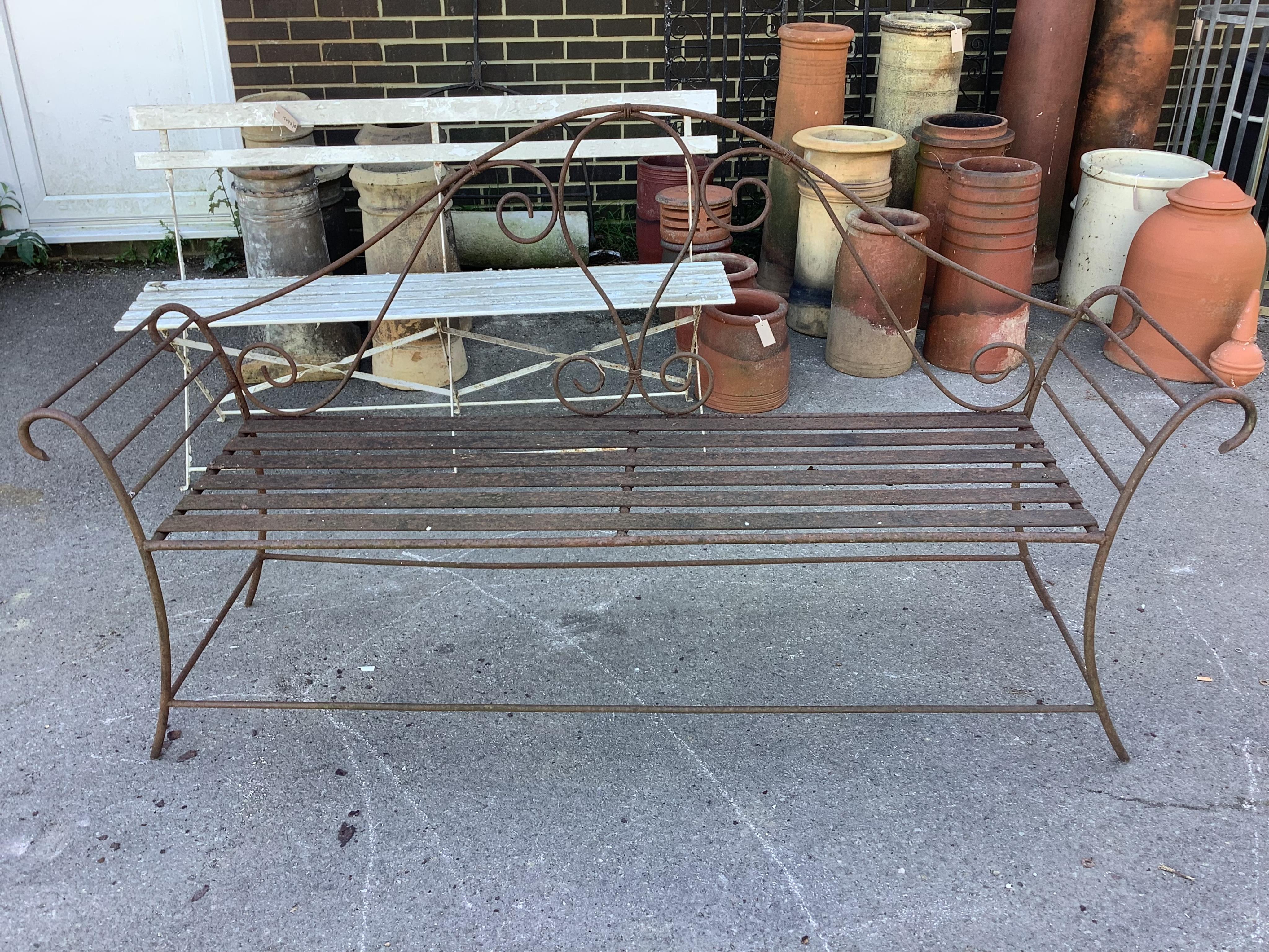 A pair of wrought iron garden benches, width 184cm, height 102cm. Condition - fair